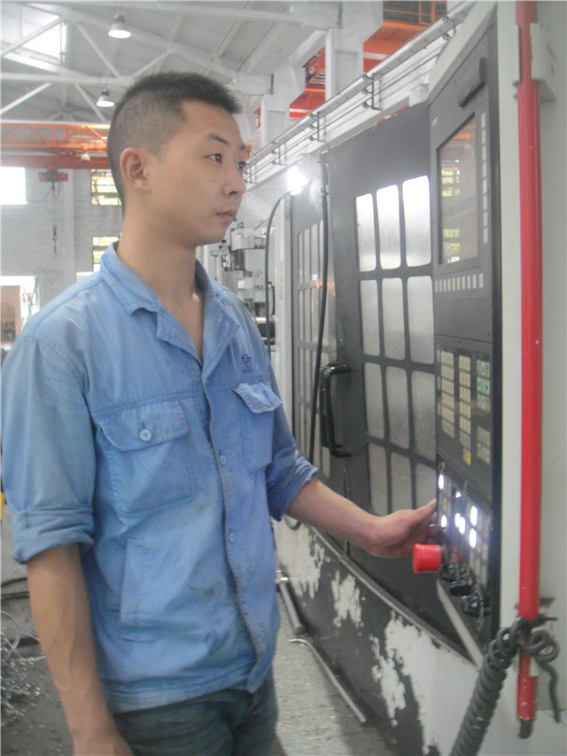 飞球公司优秀员工黄永杰.在认真操作数控机床.JPG